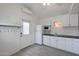 Bright kitchenette with white cabinets, sink, appliances, and tile floor at 808 W 9Th St, Tempe, AZ 85281