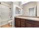 Bathroom featuring double sink vanity, neutral countertops, and tiled shower with bathtub at 9165 W Mine Trl, Peoria, AZ 85383