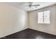 Bedroom showcasing dark wood-look flooring, a ceiling fan, and a window with blinds at 9165 W Mine Trl, Peoria, AZ 85383