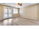 Well-lit bedroom featuring wood floors, ceiling fan and access to a balcony with scenic views at 9165 W Mine Trl, Peoria, AZ 85383