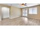 Spacious bedroom with neutral walls, wood floors, and access to a private balcony at 9165 W Mine Trl, Peoria, AZ 85383