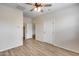 Bedroom features wood-look floors, a ceiling fan, and a door that leads to the outside at 9165 W Mine Trl, Peoria, AZ 85383