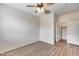 Bedroom features wood-look floors, a ceiling fan, and an attached closet for convenient storage at 9165 W Mine Trl, Peoria, AZ 85383