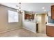 Cozy dining area with stylish chandelier, bright windows and adjacent to the kitchen at 9165 W Mine Trl, Peoria, AZ 85383