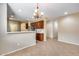 Open-concept dining area featuring a chandelier, and a view into the kitchen at 9165 W Mine Trl, Peoria, AZ 85383