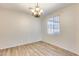 Dining room showcasing wood-look floors, a chandelier, and a window that brings in natural light at 9165 W Mine Trl, Peoria, AZ 85383