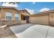 Charming front yard of home featuring a large driveway leading to the two-car garage at 9165 W Mine Trl, Peoria, AZ 85383