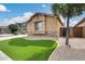 Attractive home featuring manicured front lawn with decorative rock and turf at 9165 W Mine Trl, Peoria, AZ 85383