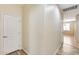 Hallway view featuring wood-look flooring and a view of the chandelier in the adjacent room at 9165 W Mine Trl, Peoria, AZ 85383