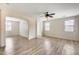 Spacious living room featuring wood-look flooring and multiple windows with blinds at 9165 W Mine Trl, Peoria, AZ 85383