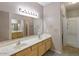 Bright bathroom with double sinks, vanity storage, and a separate shower offers comfort and style at 9455 E Raintree Dr # 2032, Scottsdale, AZ 85260