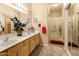 Bathroom featuring double sinks, a large mirror, a shower stall, and carpeted floors at 9455 E Raintree Dr # 2032, Scottsdale, AZ 85260