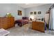 Cozy bedroom featuring a colorful quilt, dresser, sewing table, and carpeted floors at 9455 E Raintree Dr # 2032, Scottsdale, AZ 85260