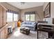 Cozy bedroom with blue accents, including a comfortable sofa, patterned pillows and a charming window valance at 9455 E Raintree Dr # 2032, Scottsdale, AZ 85260