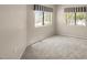 Empty bedroom with two windows offering ample natural light and neutral carpet at 9455 E Raintree Dr # 2032, Scottsdale, AZ 85260