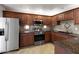 Well-equipped kitchen with stainless steel appliances and dark wood cabinets, perfect for culinary enthusiasts at 9455 E Raintree Dr # 2032, Scottsdale, AZ 85260