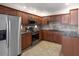Contemporary kitchen with granite countertops, stainless steel appliances, and abundant wood cabinetry at 9455 E Raintree Dr # 2032, Scottsdale, AZ 85260