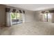 Expansive living room featuring neutral walls and large windows that offer access to outdoor balconies at 9455 E Raintree Dr # 2032, Scottsdale, AZ 85260