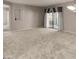 A large living room featuring neutral walls and large windows, offering natural light and outdoor access at 9455 E Raintree Dr # 2032, Scottsdale, AZ 85260