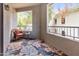 Charming outdoor patio featuring a floral rug, a comfortable wicker chair and views of the community at 9455 E Raintree Dr # 2032, Scottsdale, AZ 85260