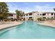 Resort-style pool with surrounding seating and views of the well-maintained community buildings at 9455 E Raintree Dr # 2032, Scottsdale, AZ 85260