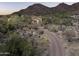 Aerial view of estate with manicured landscaping and a long driveway to the residence and golf course at 9820 E Thompson Peak Pkwy # 841, Scottsdale, AZ 85255