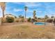 Large backyard featuring palm trees and a pool with a fence at 1018 E Tonto Ln, Phoenix, AZ 85024