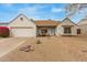 Charming single-story home featuring desert landscaping, a cozy front porch, and attached two-car garage at 1018 E Tonto Ln, Phoenix, AZ 85024