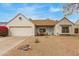 Charming home exterior with desert landscaping, two-car garage, and covered porch at 1018 E Tonto Ln, Phoenix, AZ 85024