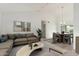 Stylishly staged living room with vaulted ceiling, comfortable seating, dining area, and large windows at 1018 E Tonto Ln, Phoenix, AZ 85024