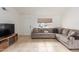 Cozy living room featuring a comfortable sectional sofa, entertainment center, and natural light at 1018 E Tonto Ln, Phoenix, AZ 85024