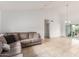 Bright living room with neutral walls, tile flooring, comfortable sofa, and sliding door to outdoor space at 1018 E Tonto Ln, Phoenix, AZ 85024