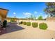 Spacious backyard featuring desert landscaping and a covered patio area at 10228 W Andover Ave, Sun City, AZ 85351