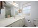 Bathroom features a marble vanity, a large mirror, and plentiful natural light at 10228 W Andover Ave, Sun City, AZ 85351