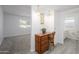 Bright bathroom features a vintage vanity and sink adjacent to the doorway at 10228 W Andover Ave, Sun City, AZ 85351