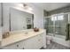 Bathroom featuring a large vanity and a glass-enclosed shower at 10228 W Andover Ave, Sun City, AZ 85351