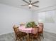 Bright dining area with wood table, seating for six, and views through the window at 10228 W Andover Ave, Sun City, AZ 85351