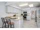 Well-lit kitchen featuring stainless steel appliances, breakfast bar, and ample counter space at 10228 W Andover Ave, Sun City, AZ 85351