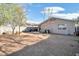 Backyard featuring a large, fenced lot with a desert landscape and patio area perfect for entertaining at 1030 E Desert Moon Trl, San Tan Valley, AZ 85143