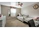 This bedroom features a cozy bed, neutral tones, and a ceiling fan for added comfort and relaxation at 1030 E Desert Moon Trl, San Tan Valley, AZ 85143