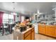 Open kitchen with dining area featuring a kitchen island, tile floors, and a seamless flow for entertaining at 1030 E Desert Moon Trl, San Tan Valley, AZ 85143