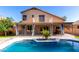 Beautiful backyard pool with a charming patio and an attractive two-story home with balcony, perfect for outdoor living at 10452 E Florian Ave, Mesa, AZ 85208