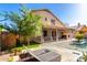 Serene backyard featuring a refreshing pool, covered patio with elegant drapes, and a well-manicured lawn, perfect for relaxation at 10452 E Florian Ave, Mesa, AZ 85208