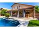 Inviting backyard pool featuring an outdoor bar and a second-story balcony, perfect for relaxation and entertainment at 10452 E Florian Ave, Mesa, AZ 85208