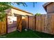 Enclosed backyard with artificial turf and a wooden fence, offering a private outdoor space at 10452 E Florian Ave, Mesa, AZ 85208