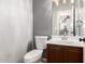 Powder room featuring a single sink, white toilet, and modern fixtures at 10452 E Florian Ave, Mesa, AZ 85208