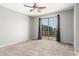 Spacious bedroom features a ceiling fan, and sliding glass door leading to a private balcony at 10452 E Florian Ave, Mesa, AZ 85208