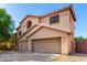 Two-story home featuring a two-car garage, neutral colors, and desert landscaping at 10452 E Florian Ave, Mesa, AZ 85208
