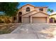 Two-story home featuring a two-car garage, neutral colors, and desert landscaping at 10452 E Florian Ave, Mesa, AZ 85208