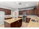 Gourmet kitchen featuring granite countertops, stainless steel appliances, and dark wood cabinets at 10452 E Florian Ave, Mesa, AZ 85208